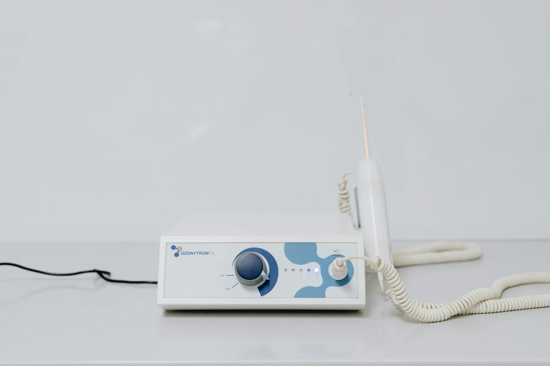 A high-tech ozone therapy device with a minimalistic design on a white background.
